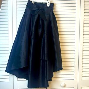 High low satin skirt with bow belt .